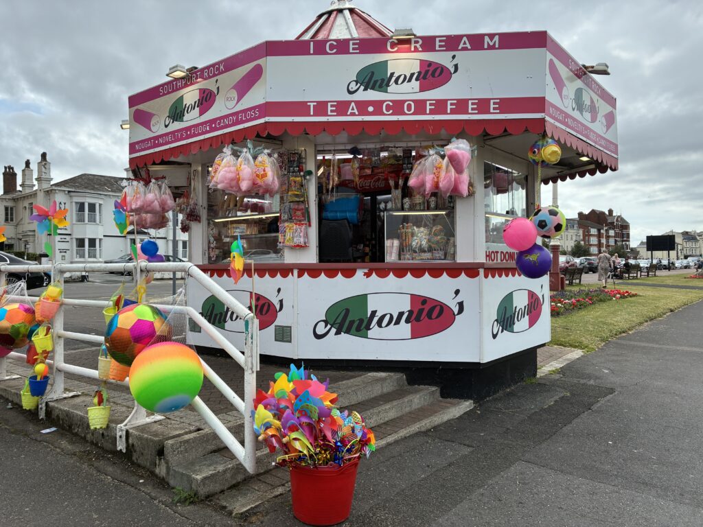 Antonio’s kiosk in classic seaside style, bursting with bright buckets, pinwheels, candy floss and beach balls. One of many vibrant sights captured during our first photo trip along the Liverpool–Southport line.